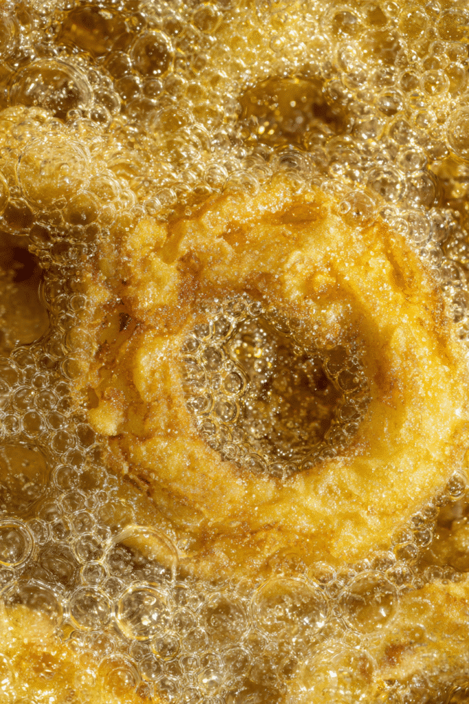 Apple cider donuts frying in hot oil