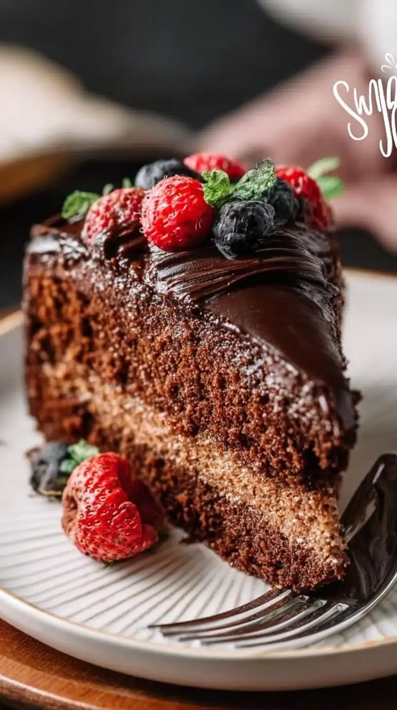 Delicious slice of Black Magic Cake topped with chocolate frosting