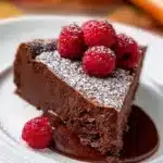 Rich flourless chocolate cake topped with chocolate ganache